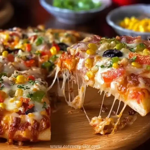 Hot homemade vegetable pizza slice with melted cheese, olives, and colorful toppings