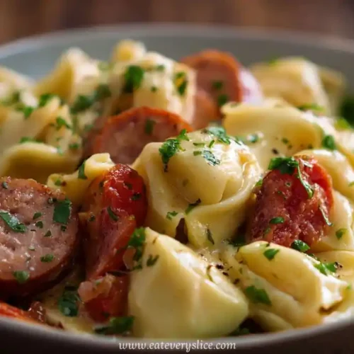Creamy crockpot pierogi casserole with kielbasa slices, garnished with parsley