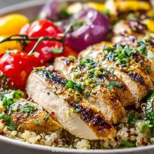 grilled chicken breast over quinoa with cherry tomatoes, zucchini, red onion, and herbs