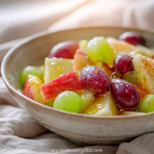 fresh fruit salad with red apples, green grapes, pineapple chunks and cinnamon glaze