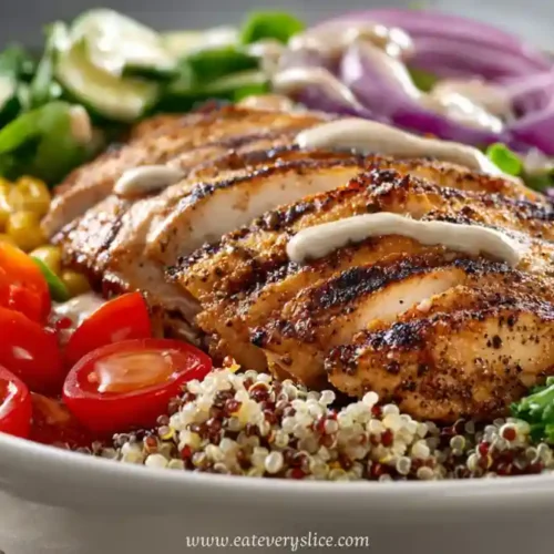 grilled chicken breast with quinoa, cherry tomatoes, corn, and vegetables in a protein bowl