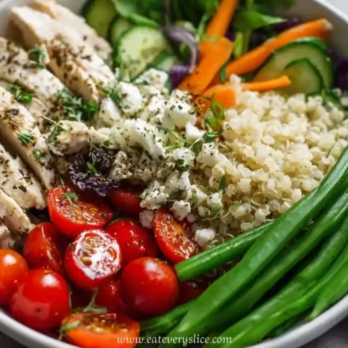 bowl with herbed chicken, quinoa, green beans, cherry tomatoes, and fresh vegetables