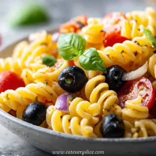 pasta salad with olives cherry tomatoes basil and herbs in bowl with logo and text