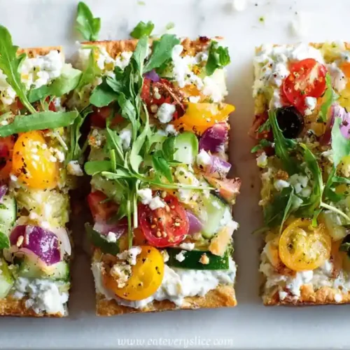mediterranean flatbread with tomatoes olives cucumber feta cheese and arugula