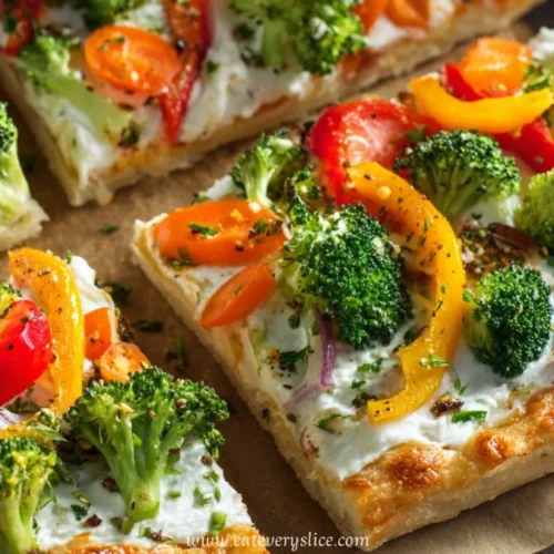 veggie sheet pan pizza with broccoli bell peppers onions and melted cheese on crispy crust