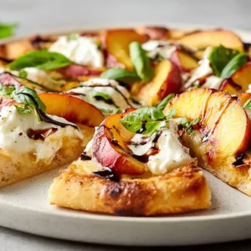Juicy peach burrata pizza with fresh basil and balsamic glaze